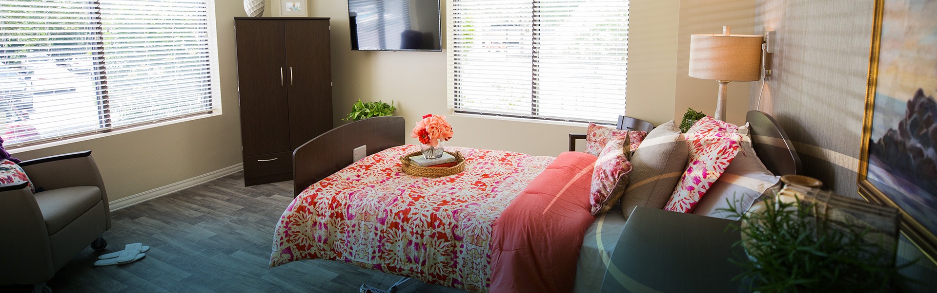 Bedroom with a rolling bed facing the window and an orange abstract bedspread