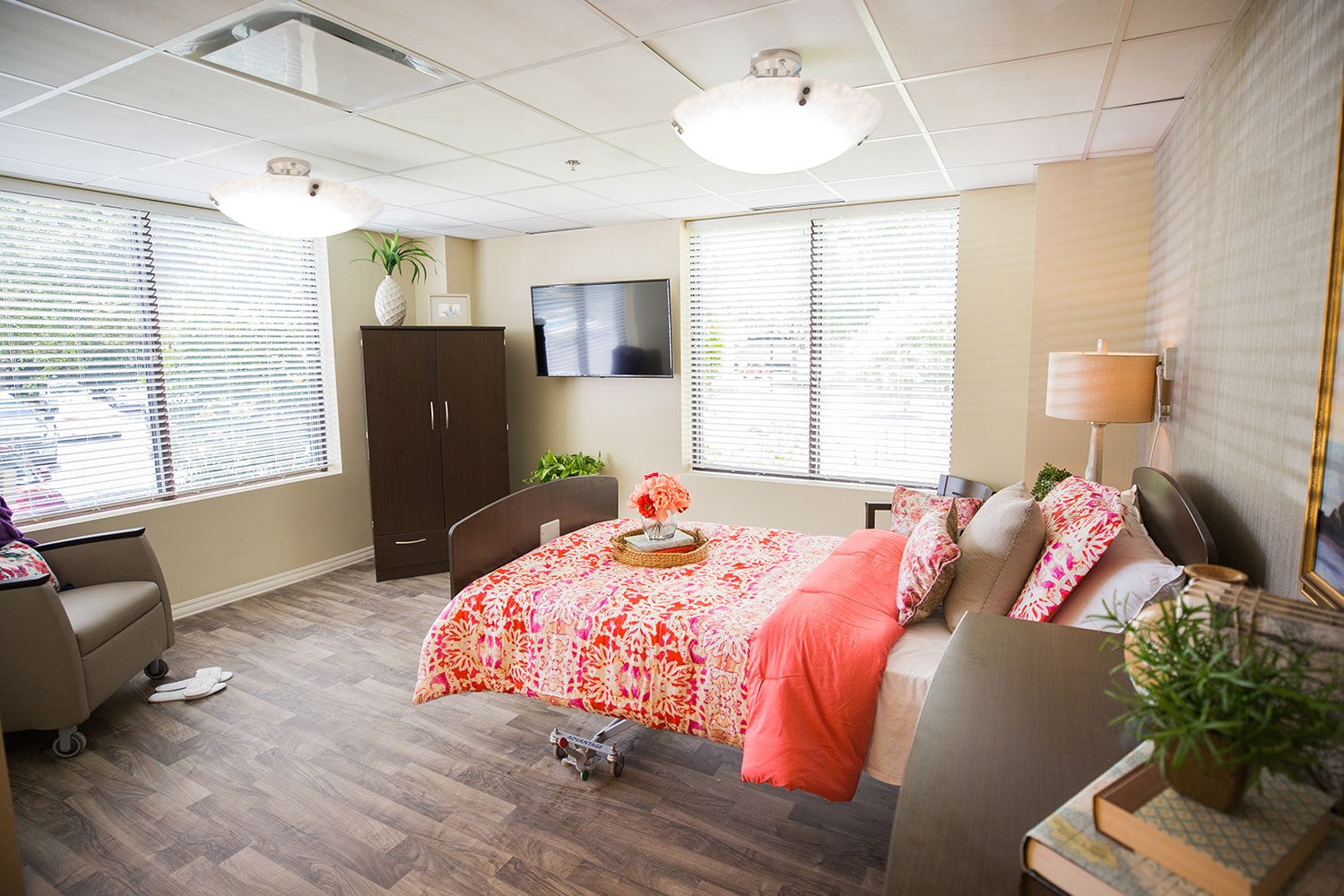 Bedroom with a rolling bed facing the window and an orange abstract bedspread