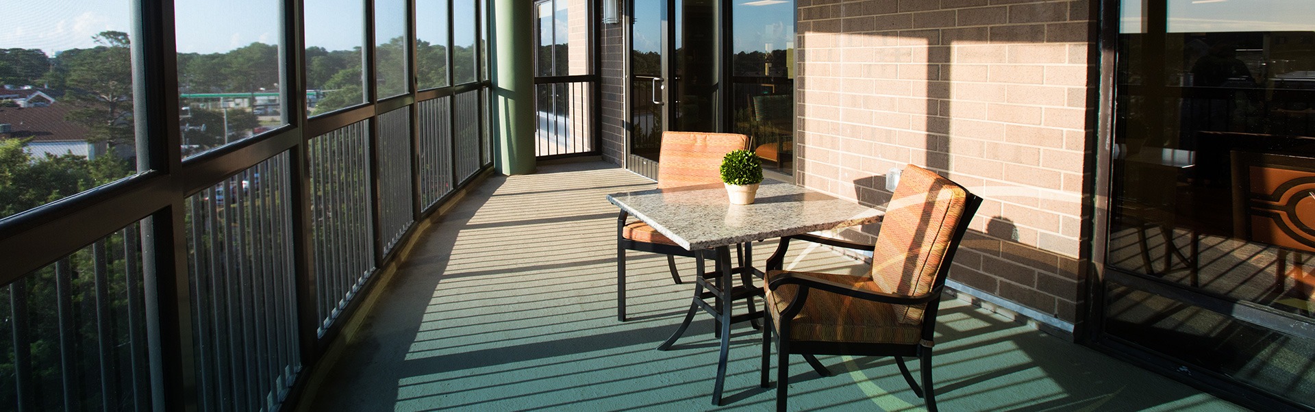 Covered porch with a small table and two chairs facing out to the view